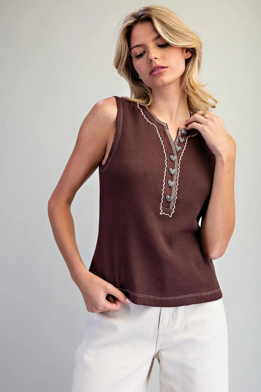chocolate brown sleeveless henley top with contrast stitching and heart-shaped buttons.