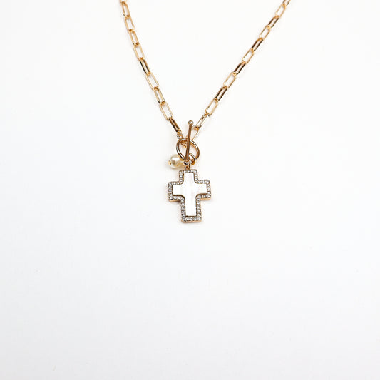 A chic gold cross charm necklace featuring a modern paperclip chain and a beautifully crafted cross pendant, perfect for layering or wearing alone.
