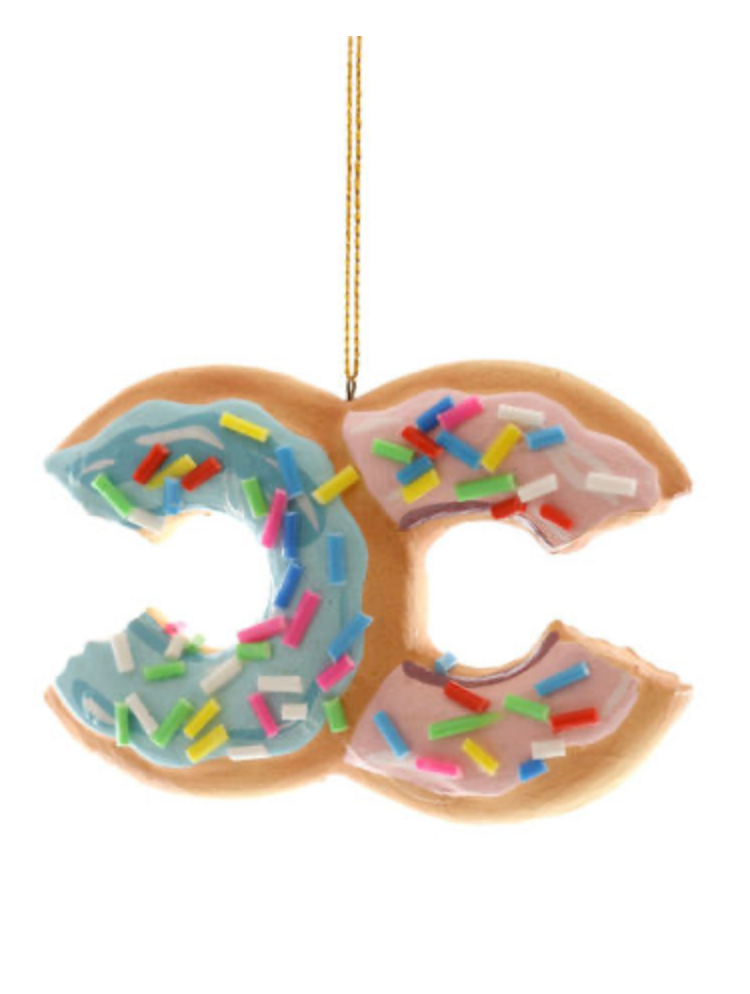 High fashion donut ornament with pastel frosting, colorful sprinkles, and designer-inspired shape, hanging luxury holiday decor.