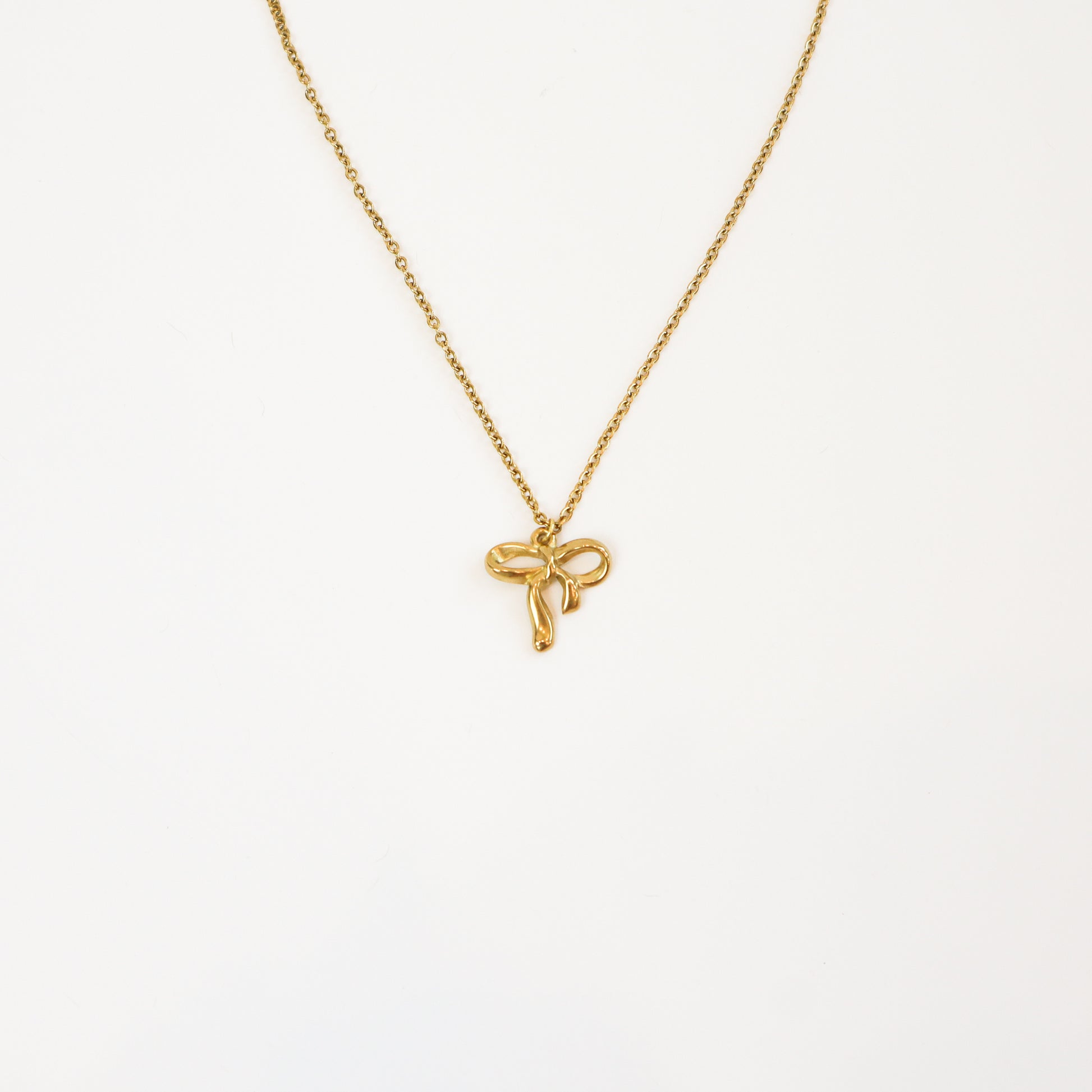 Intricate Bow Necklace with delicate gold bow pendant on a fine chain