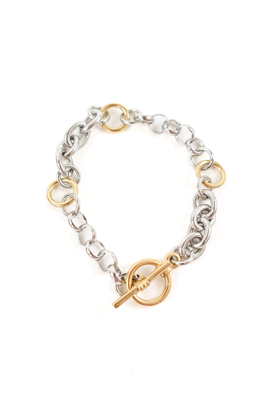 Mixed metal chain bracelet featuring gold and silver links with a toggle clasp