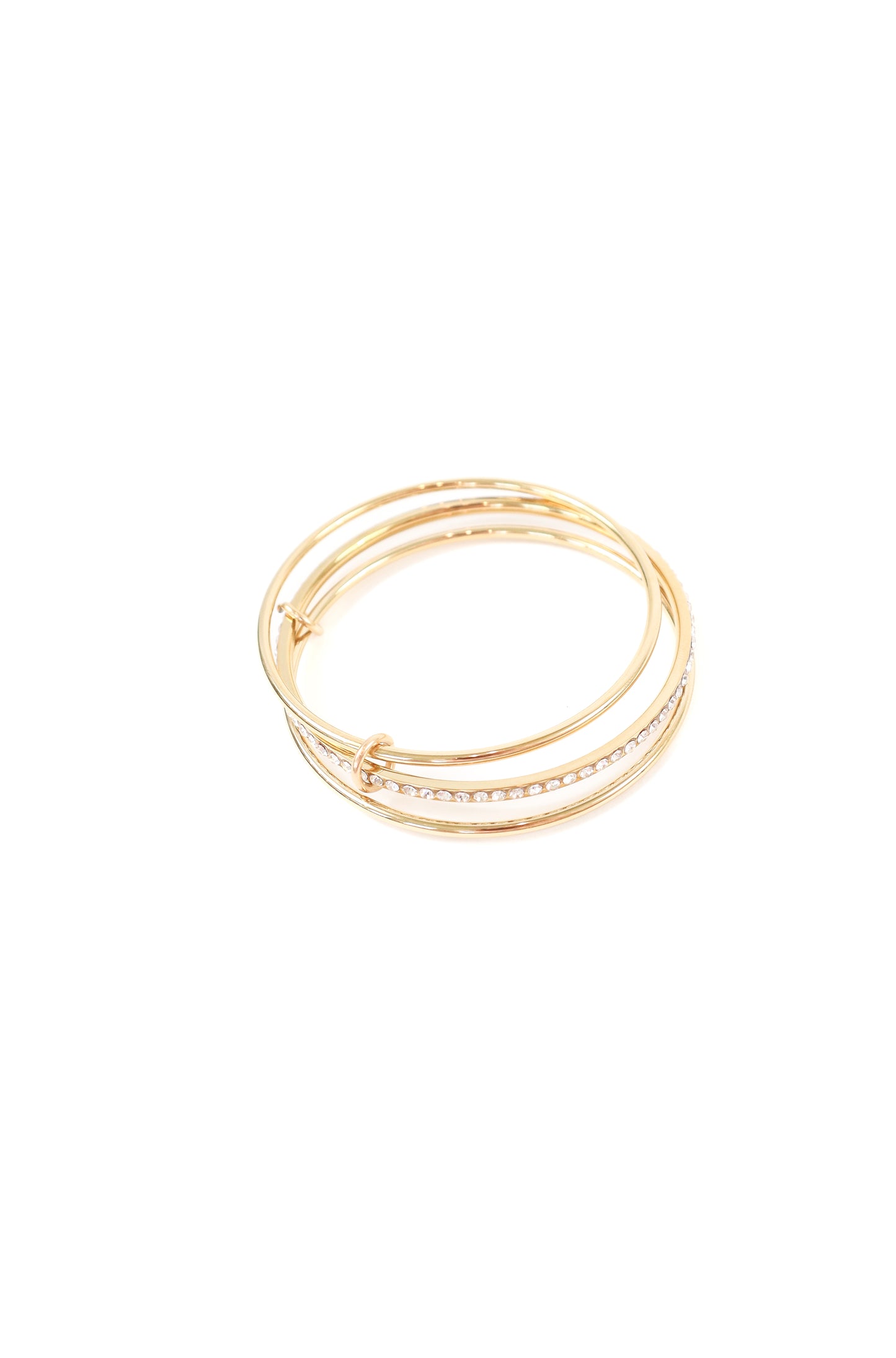 Gold triple-wrap bracelet with pavé crystal accent band and polished layered design on white background.