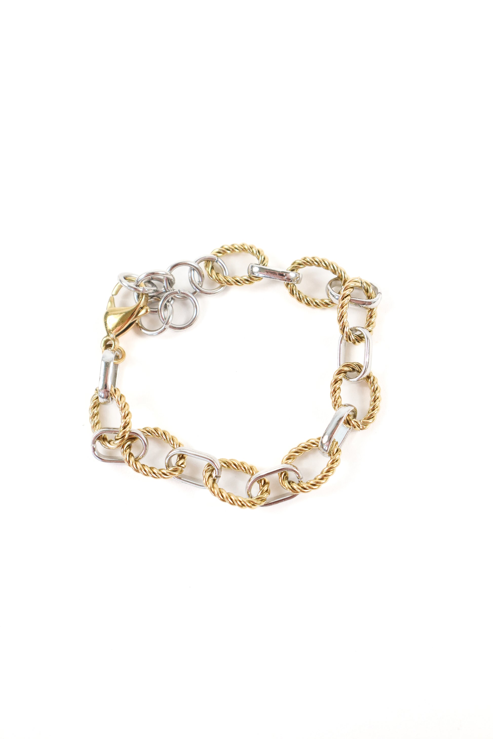 Chunky mixed metal chain bracelet featuring gold rope links and silver elongated links