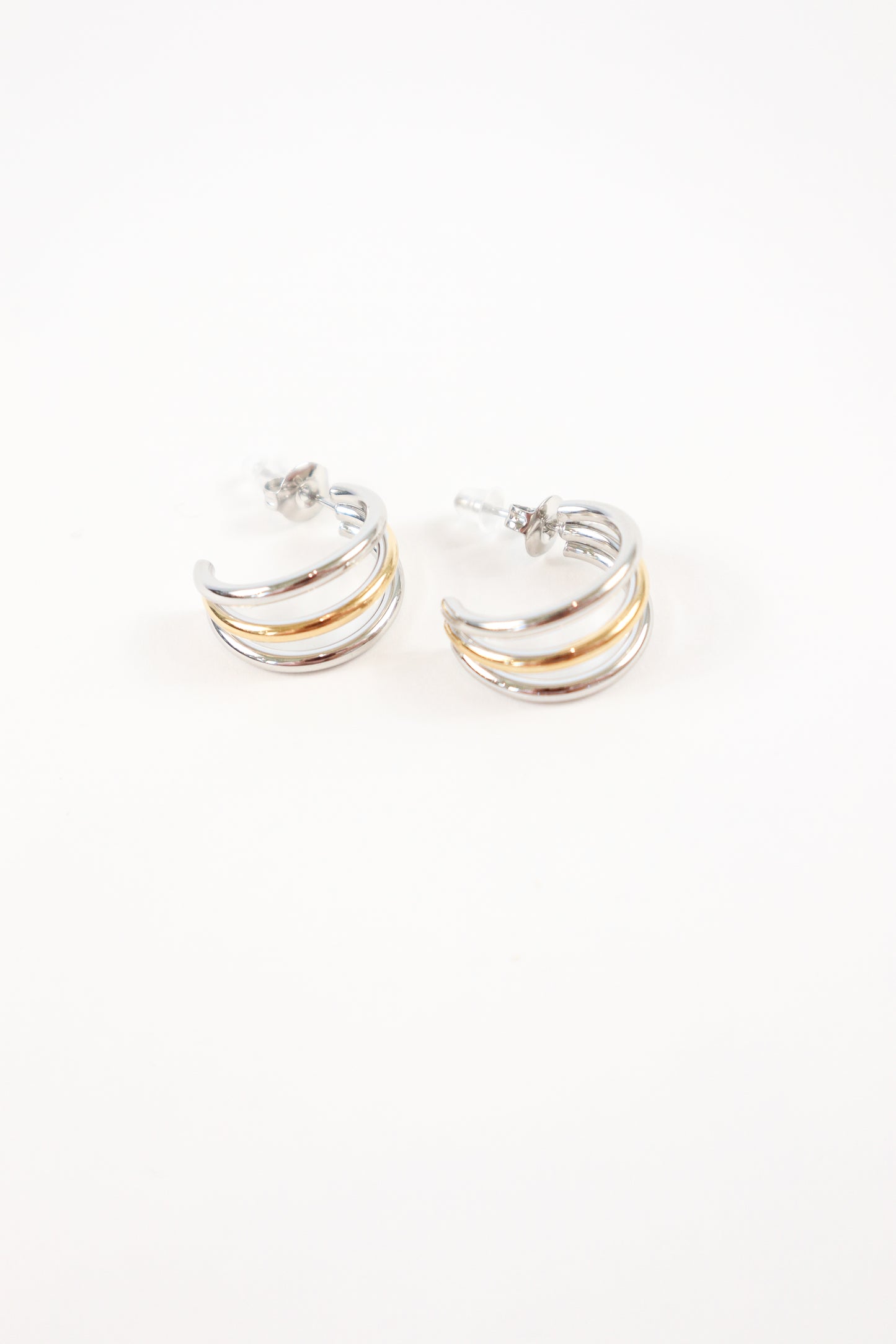 Modern mixed metal half hoop earrings with stud backing
