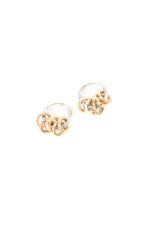 Mixed metal hoop earrings with interlocking gold rings and silver hoops