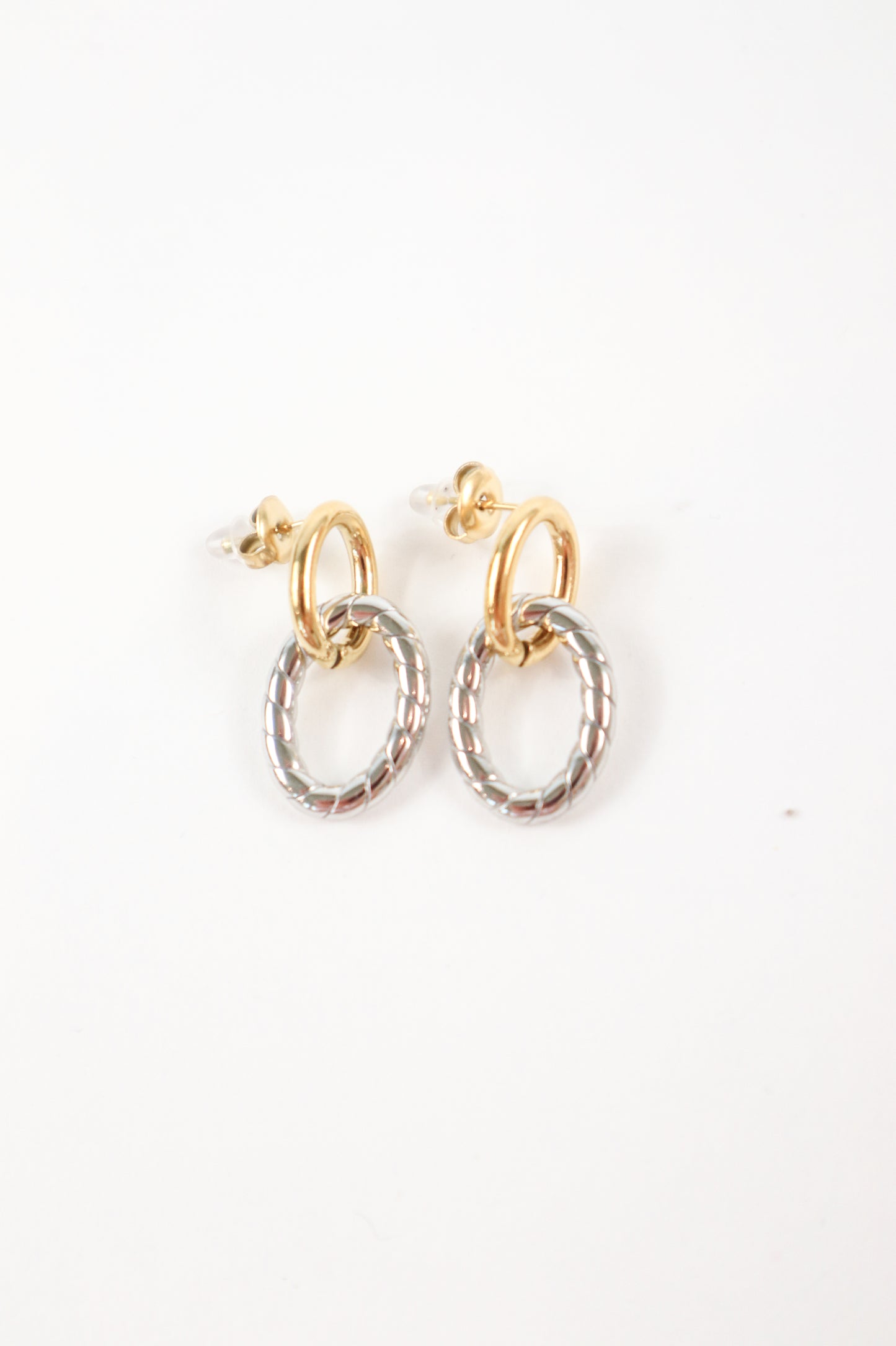 Two-tone gold and silver twist drop earrings with textured oval charm and polished gold hoop