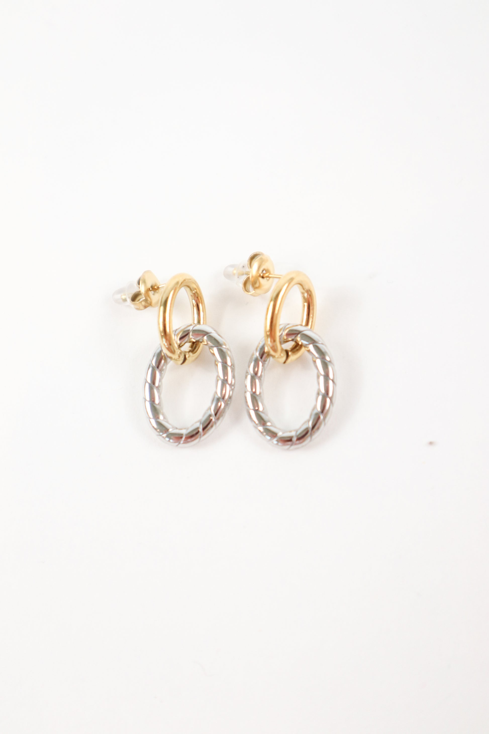 Two-tone gold and silver twist drop earrings with textured oval charm and polished gold hoop