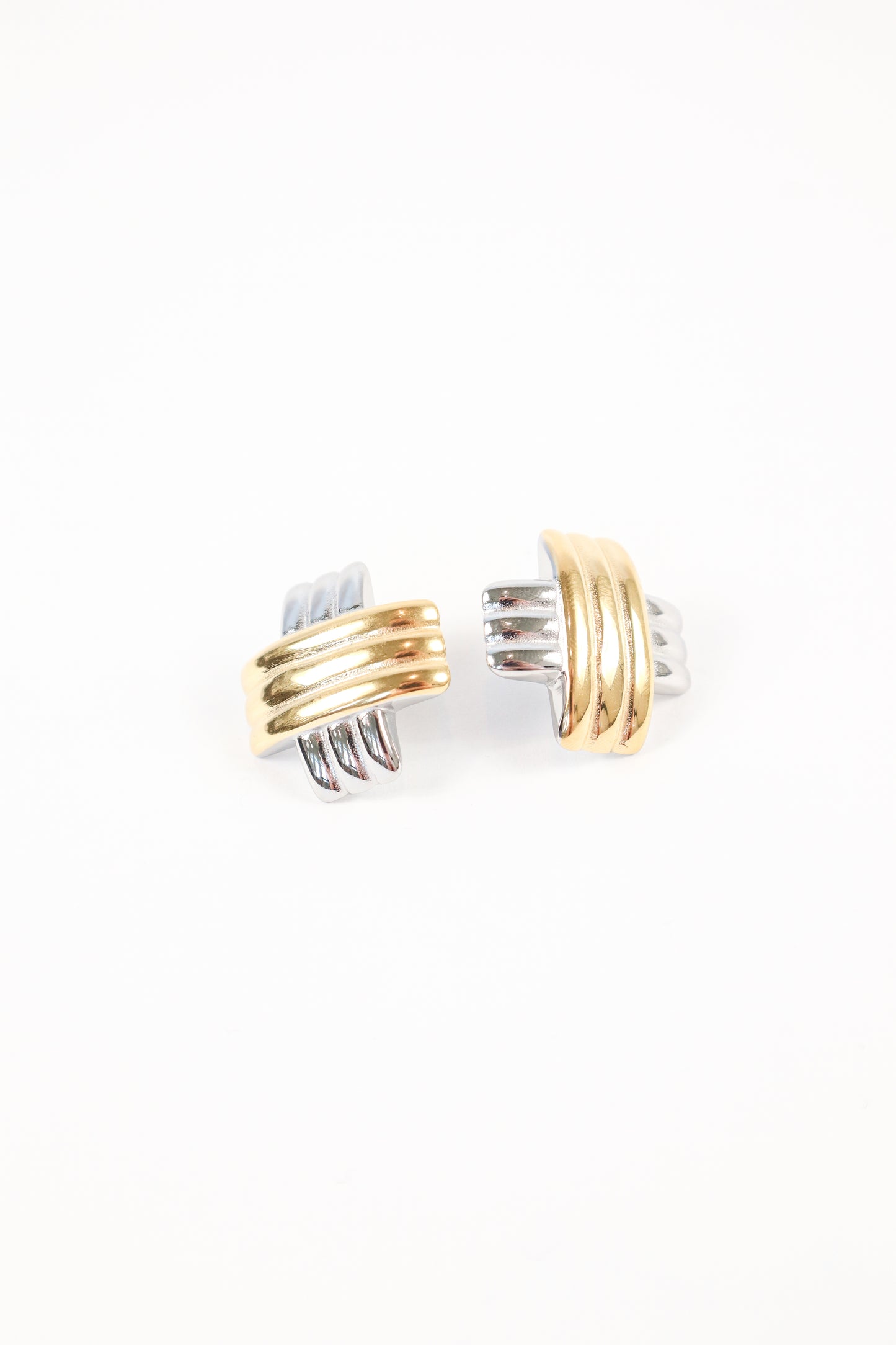 Two-tone gold and silver interlocking earrings on white background