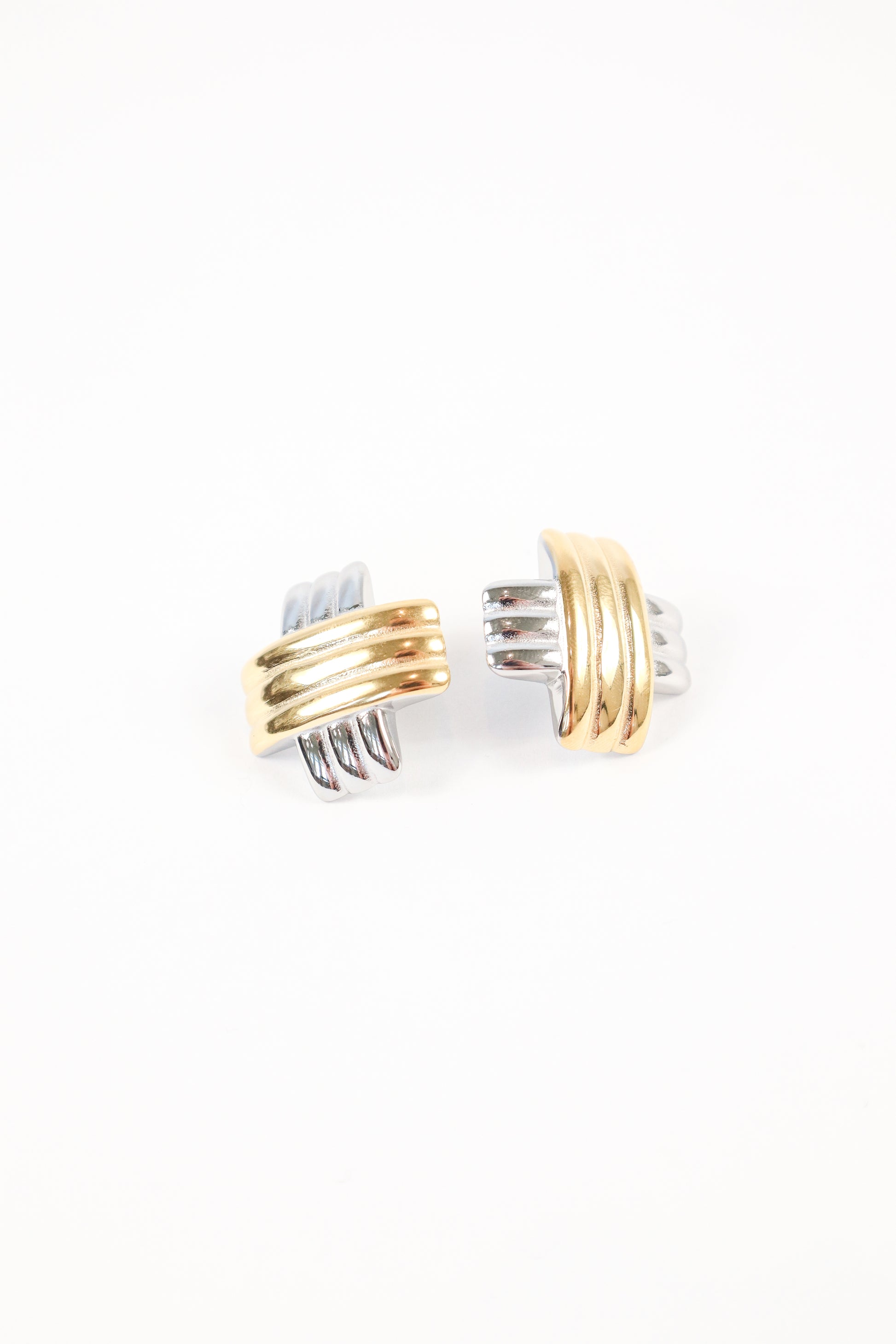 Two-tone gold and silver interlocking earrings on white background