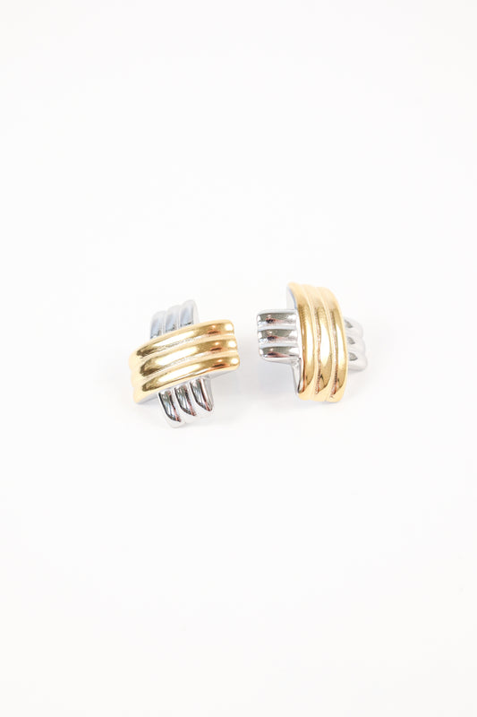 Two-tone gold and silver interlocking earrings on white background