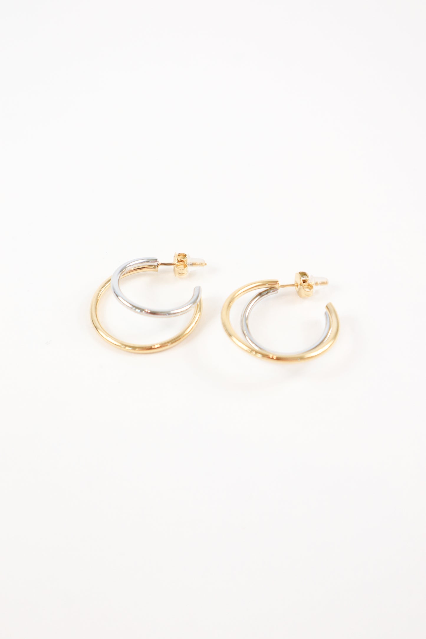 Two-tone gold and silver double hoop earrings with polished finish and post back closure