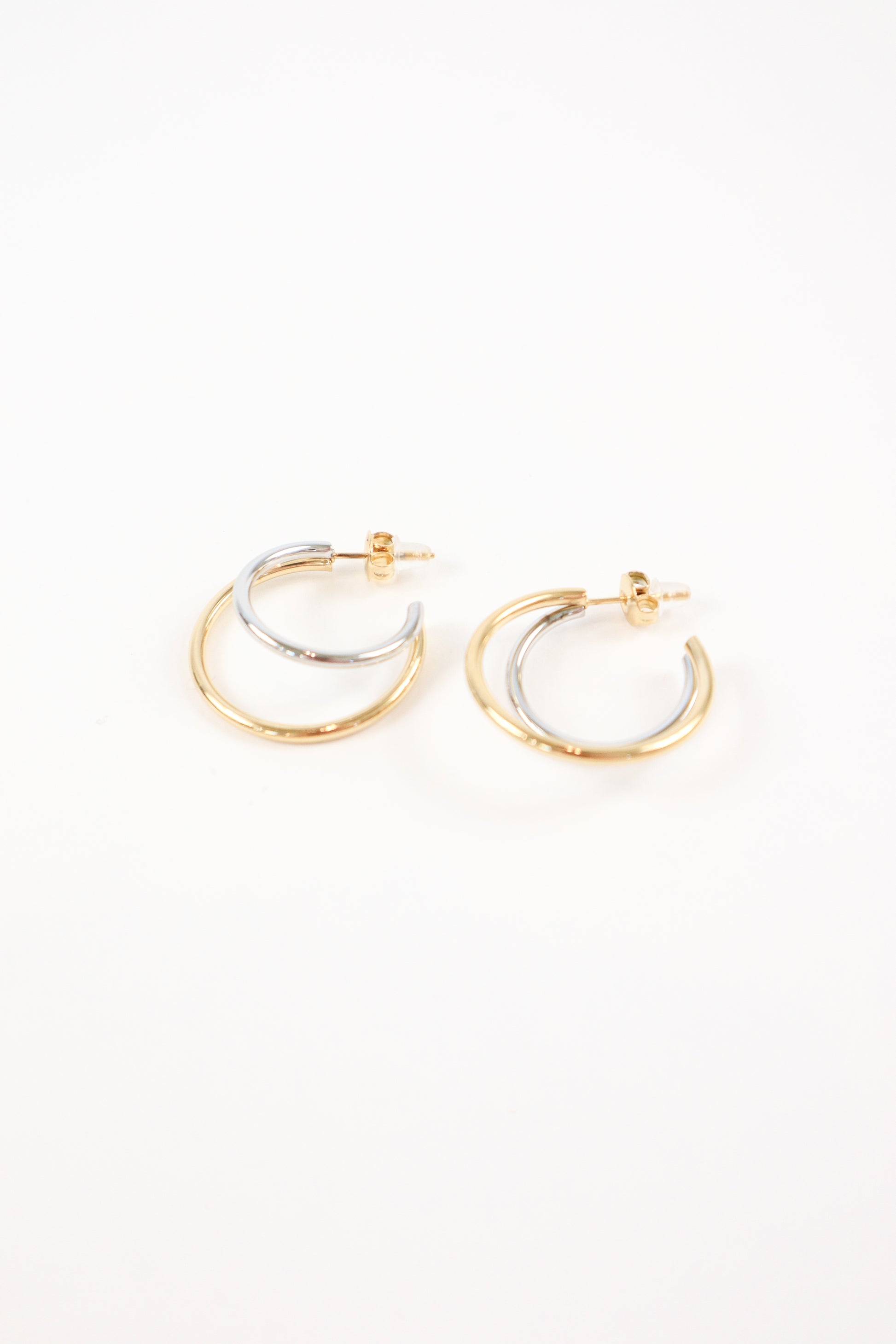 Two-tone gold and silver double hoop earrings with polished finish and post back closure