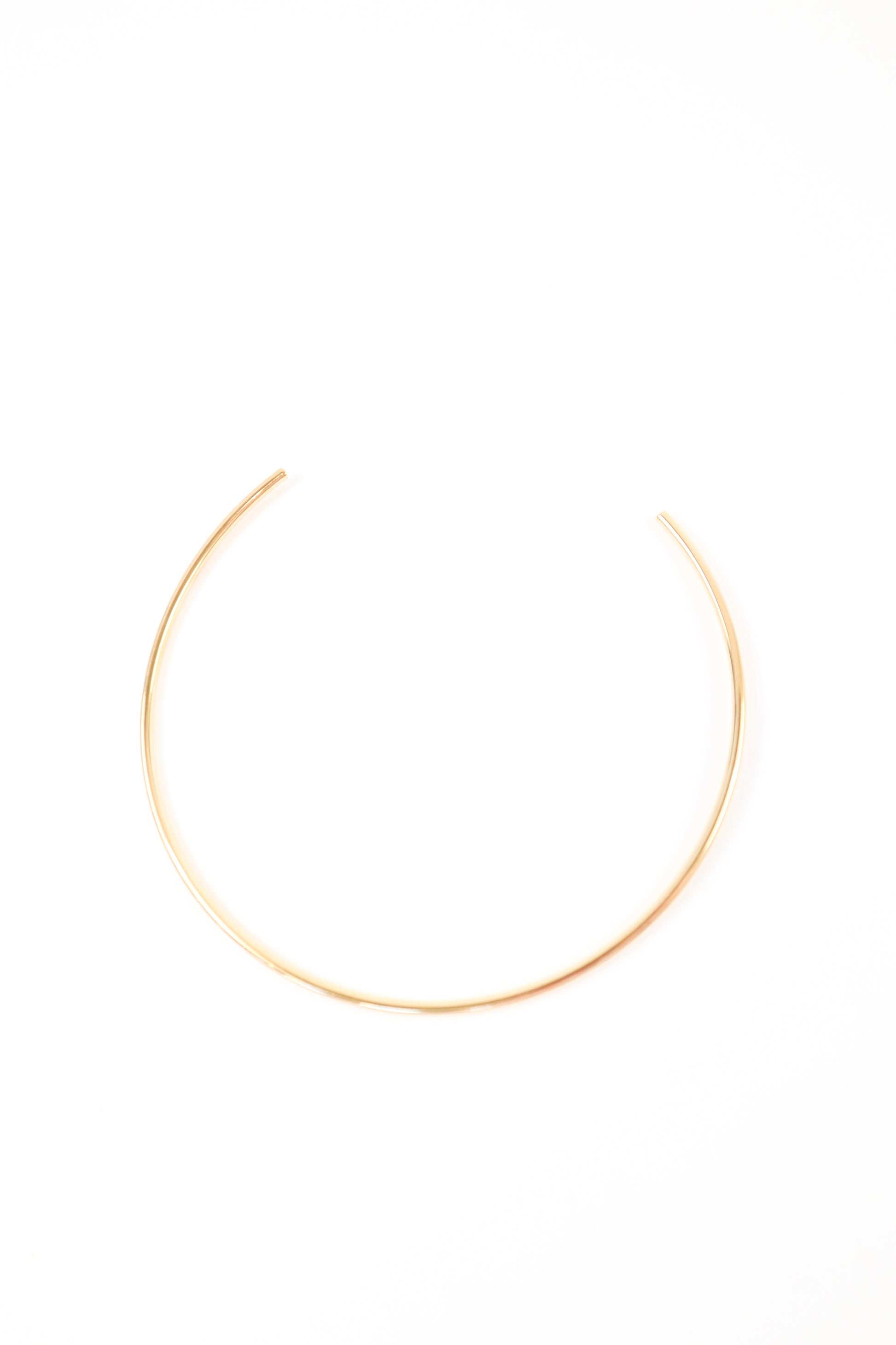Minimalist gold open collar necklace with sleek high-polish finish
