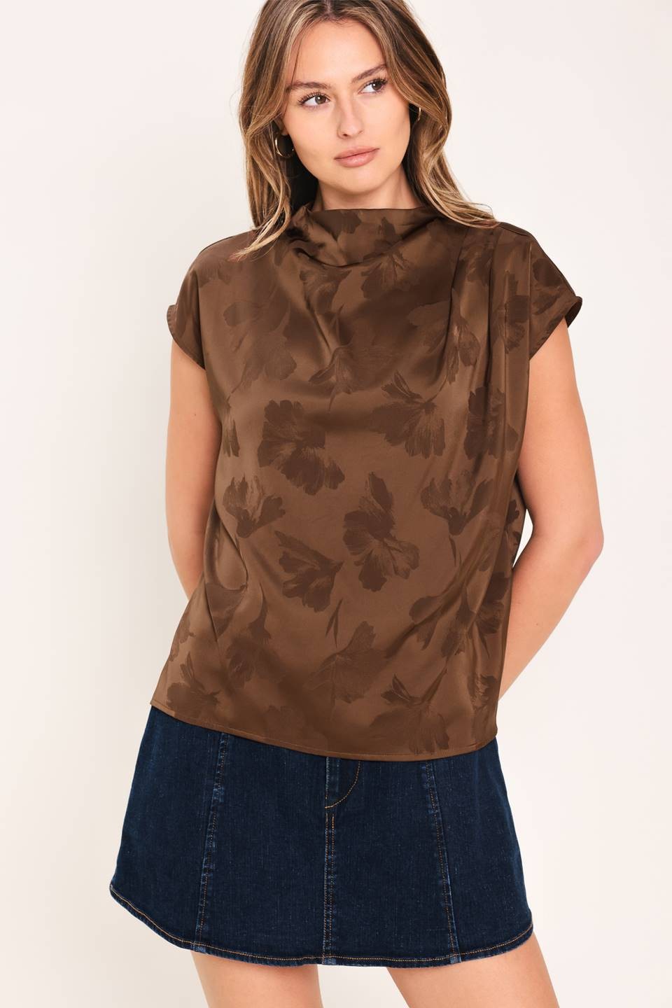 Chic woven jacquard top featuring a sophisticated funnel neckline, short sleeves, and a polished back zipper closure.
