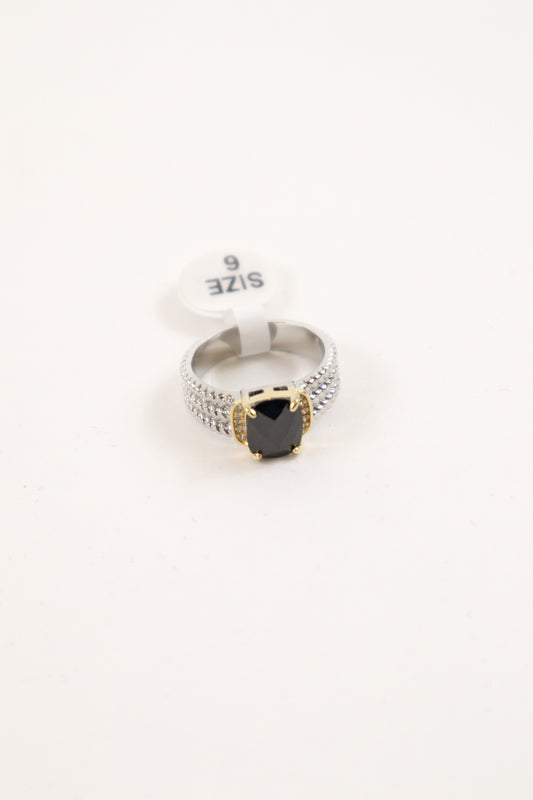Mixed metal statement ring with black cushion-cut stone, gold prongs, and pavé crystal silver band