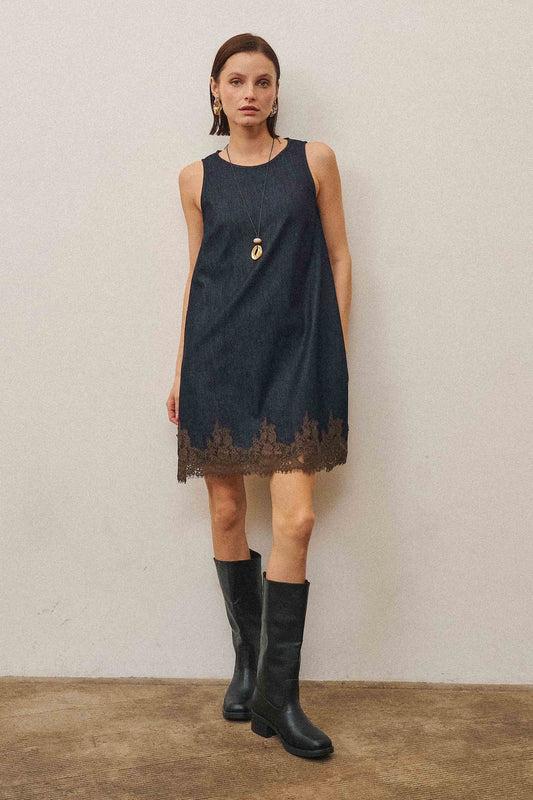 A feminine denim shift dress featuring delicate lace trim, a flattering sleeveless silhouette, and soft stretch denim for effortless all-day style.
