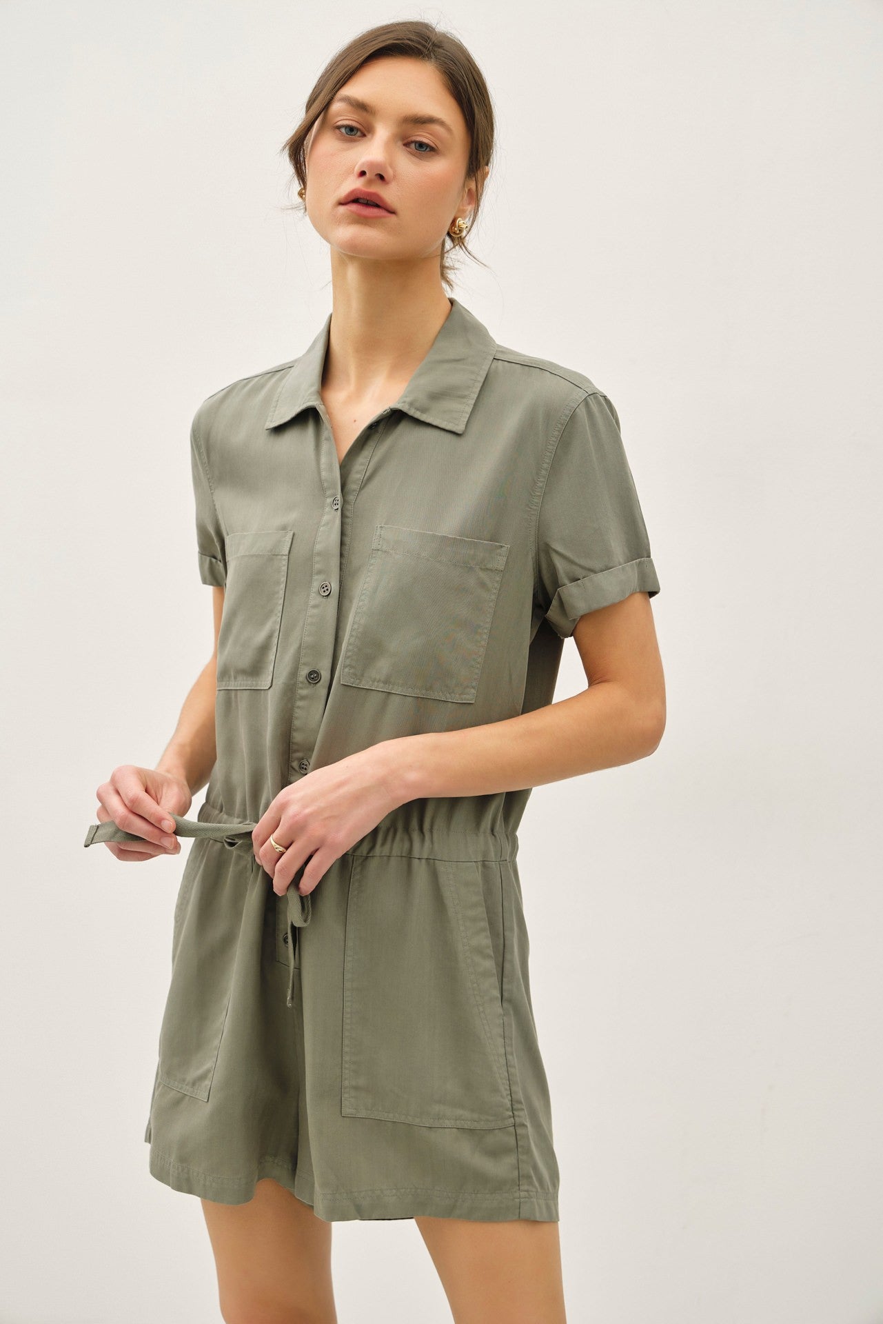 Lightweight Tencel romper with roll-cuff sleeves, drawstring waist, and effortless polish.

