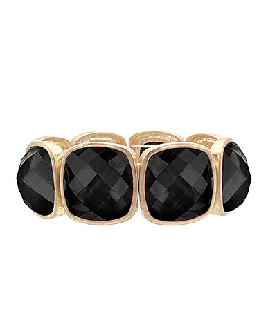 A gold-colored metal bracelet with multifaceted black gemstones set in a stretch design.