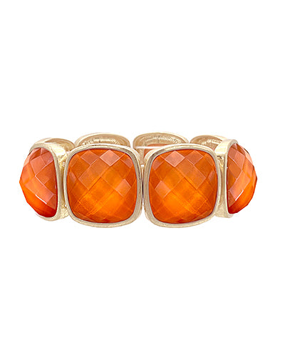 A gold-colored metal bracelet with multifaceted Dark Orange gemstones set in a stretch design.