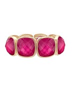 A gold-colored metal bracelet with multifaceted magenta gemstones set in a stretch design.