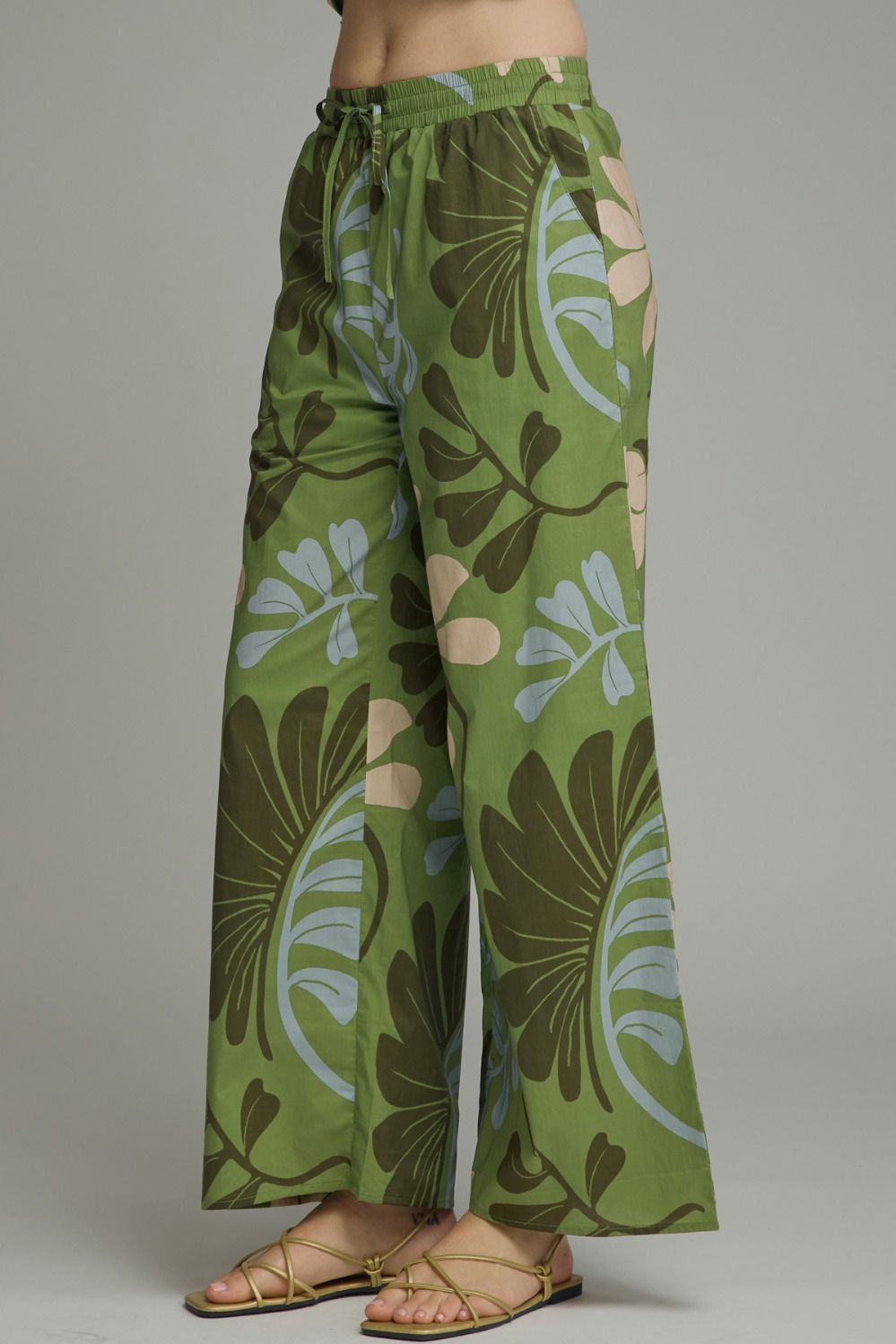 Lightweight floral wide leg pants featuring a comfortable drawstring waistband and effortless flowy silhouette for everyday elegance.
