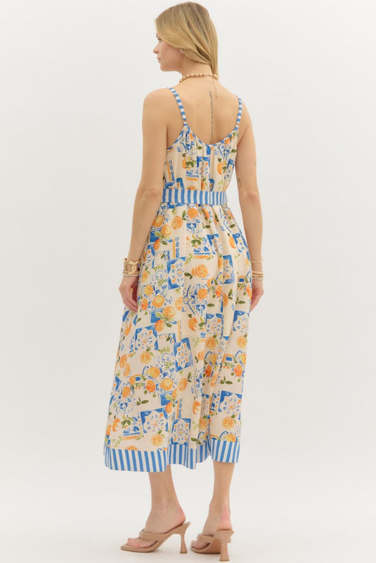 Multi-print adjustable shoulder strap pullover midi dress featuring stripe contrast accent. Removable tie at waist. Pockets at sides. Lined. Woven. Non-sheer. Lightweight.
