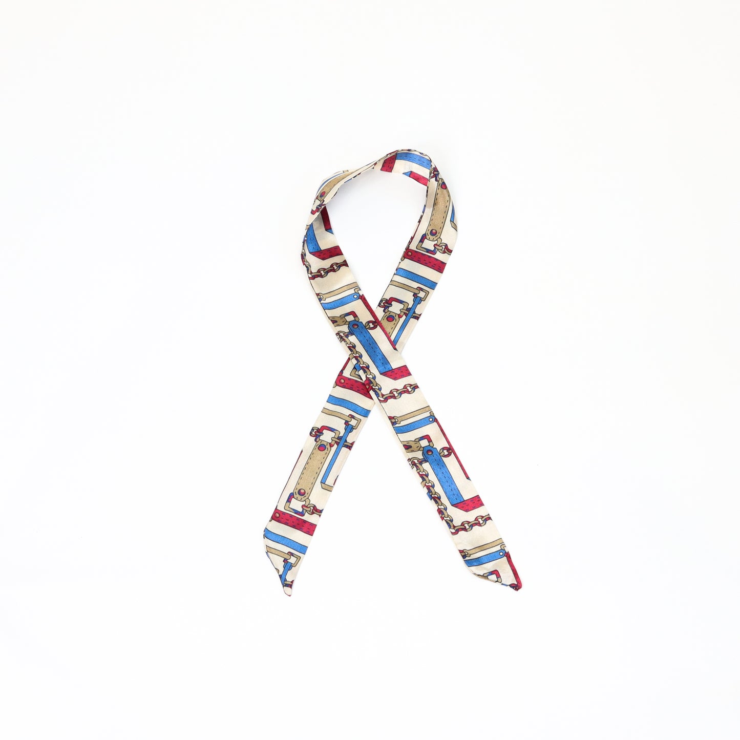 A multicolored twilly scarf with a mix of vibrant patterns