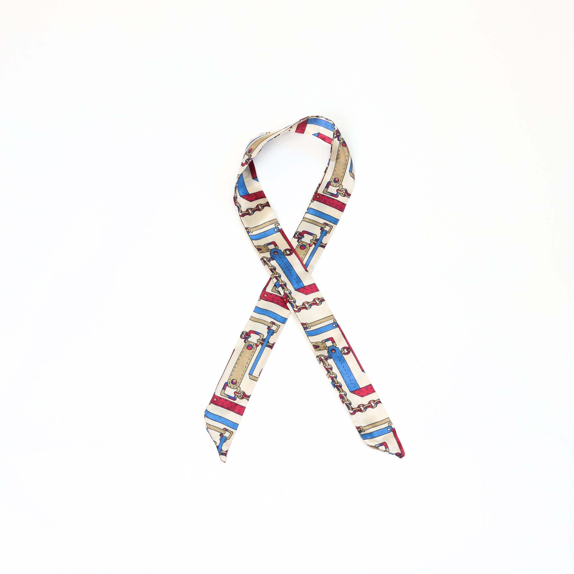 A multicolored twilly scarf with a mix of vibrant patterns