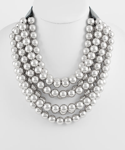 The Araminta Silver Luxe Multi-Strand Necklace makes a bold, luminous statement for any occasion.