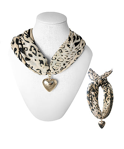 The Ottilie Leopard Heart Scarf Necklace blends playful leopard print with chic gold accents for a bold statement.