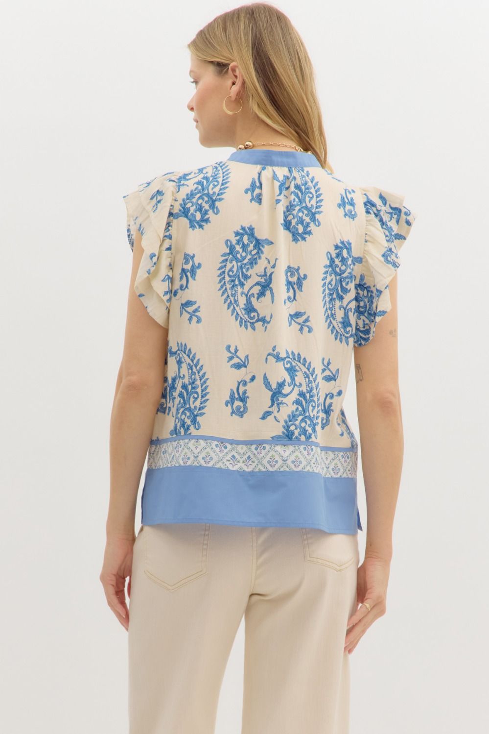 Paisley print tiered flutter sleeve pullover with multi-contrast band and hem details.

