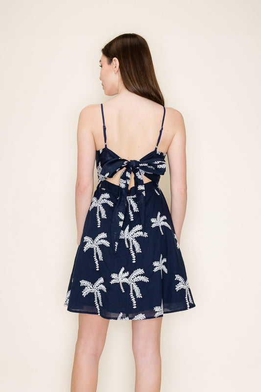 Palm print mini dress with a playful tie-back design and breezy silhouette.