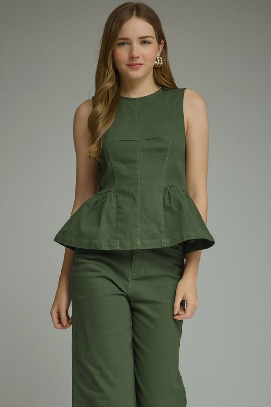 A timeless sleeveless peplum top featuring a flattering silhouette, clean lines, and lightweight woven fabric for effortlessly polished style.