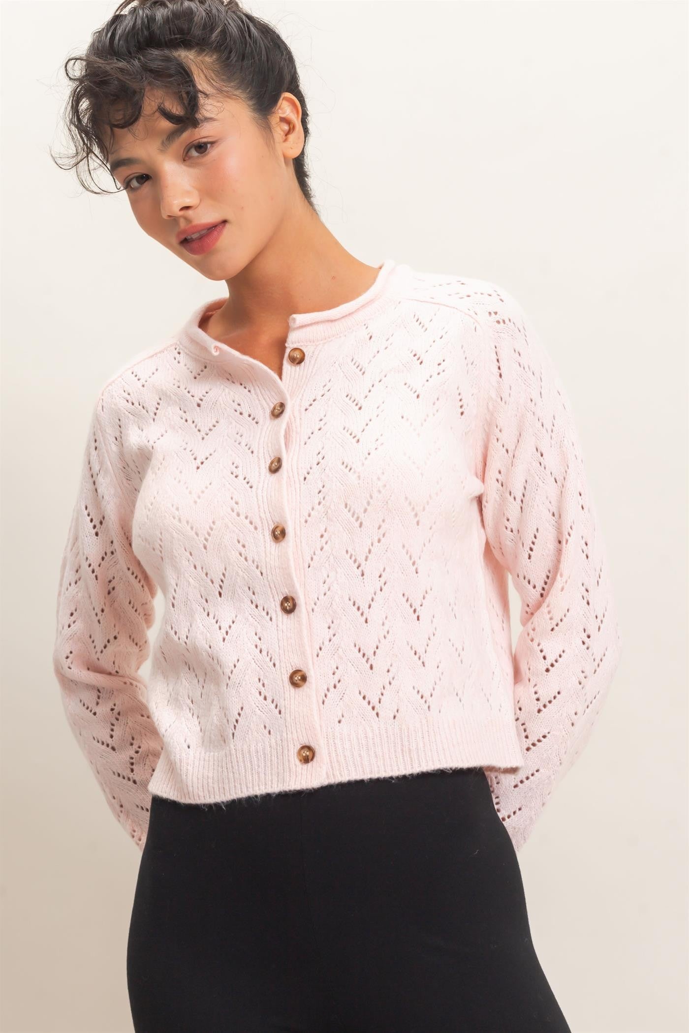 A timeless layering essential, this pointelle knit cardigan features a slightly cropped silhouette, button-front styling, and delicate details for effortless everyday charm.