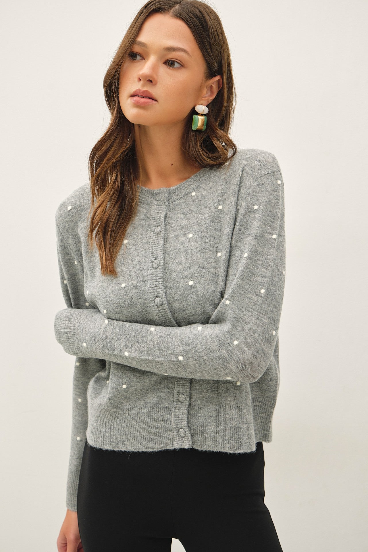 a light gray knit cardigan with small white embroidered dots and button-front closure, crew neckline,