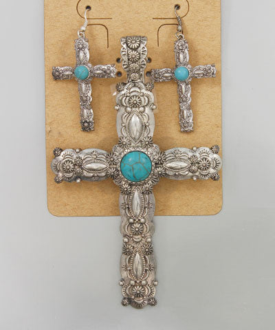 Western-style silver cross pendant and matching earrings with genuine turquoise stones on display card.