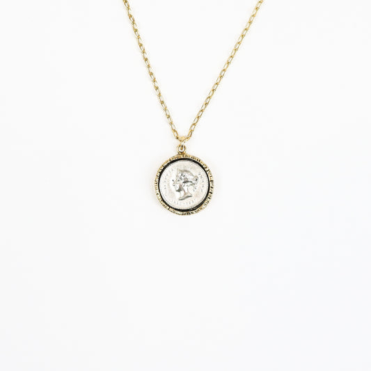 A 22K gold-plated necklace featuring a Roman emperor coin pendant encased in a textured gold frame, suspended on a delicate paperclip chain for a timeless, regal look.