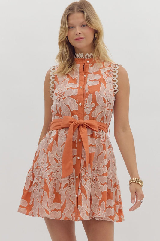 Romantic sleeveless mini dress with floral embroidery, pearl buttons, and scalloped lace trim—perfect for summer garden parties.
