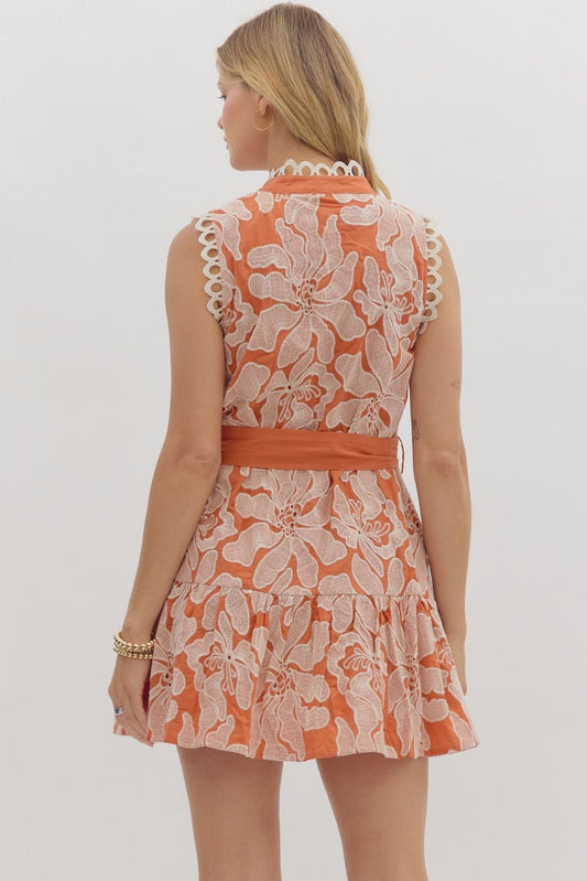 Romantic sleeveless mini dress with floral embroidery, pearl buttons, and scalloped lace trim—perfect for summer garden parties.

