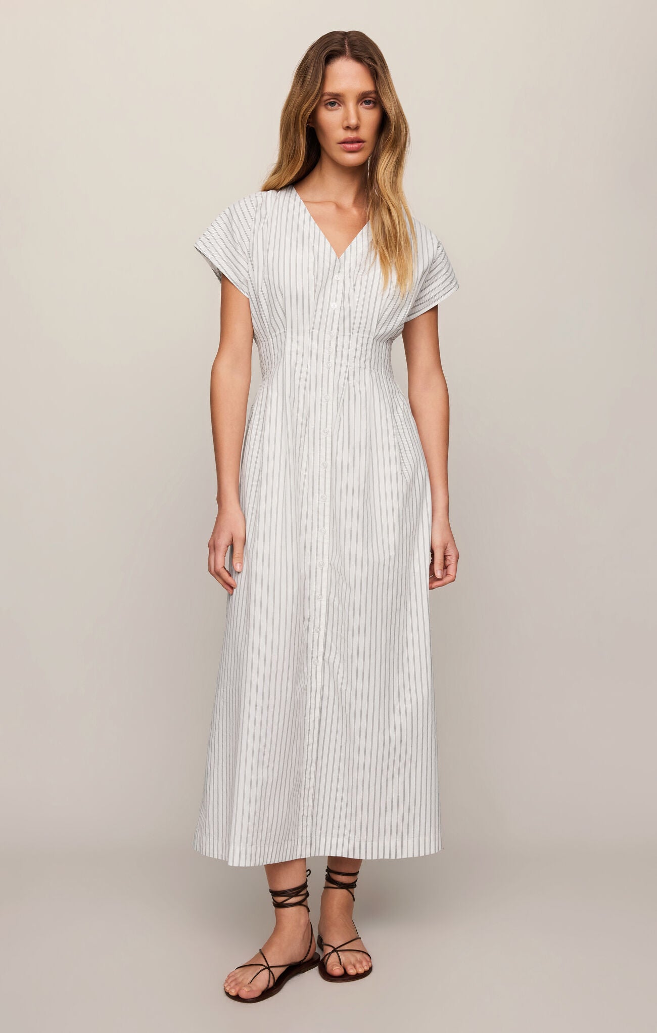 A classic cotton poplin midi dress featuring a flattering V-neckline, button front, and timeless striped design