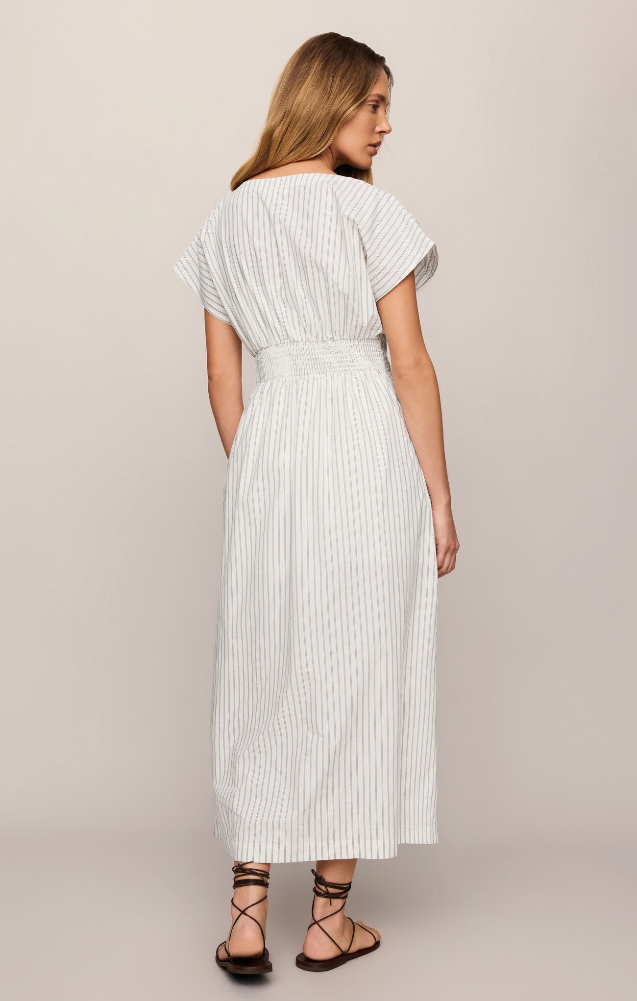 Back view cotton poplin midi dress featuring a flattering V-neckline, button front, and timeless striped design