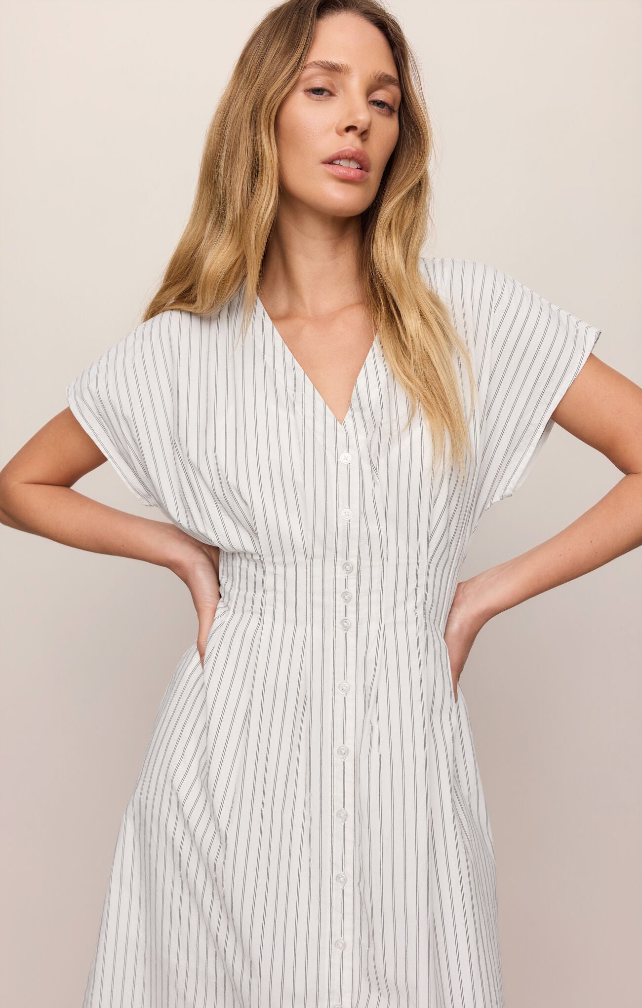 close up cotton poplin midi dress featuring a flattering V-neckline, button front, and timeless striped design 