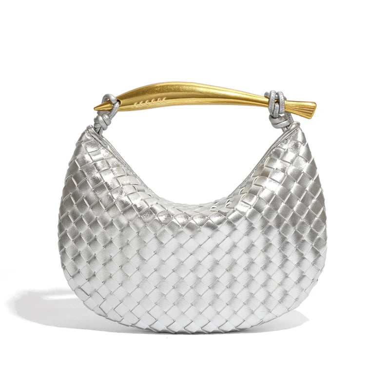 woven leather handbag with a bold gold sculptural handle for a modern, luxury look.