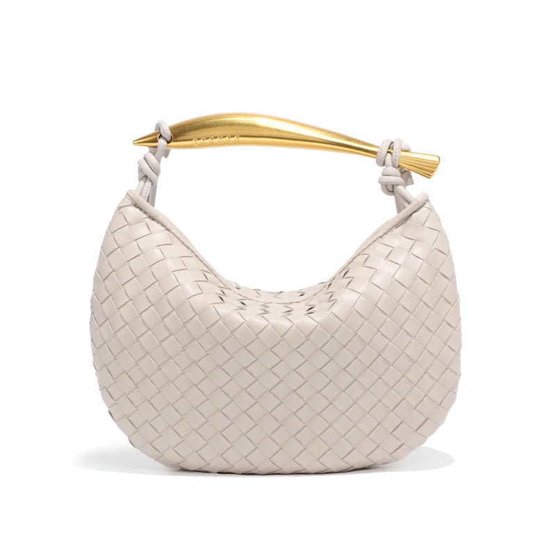 woven leather handbag with a bold gold sculptural handle for a modern, luxury look.