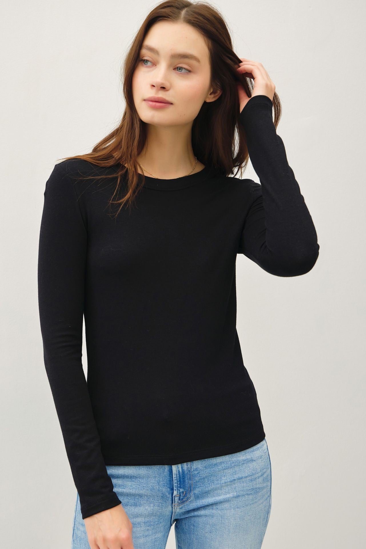Soft stretch knit pullover with a classic round neck and relaxed slim fit.