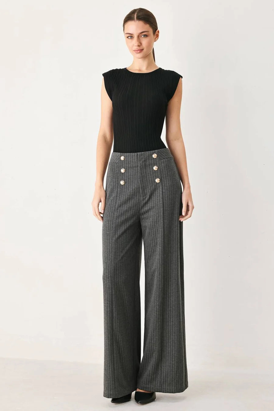 high-waisted, wide-leg gray pinstriped trousers with double rows of gold buttons