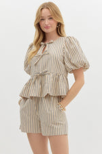 Striped Serenity Peplum Blouse with puff sleeves, bow-tie details, and a flattering peplum waist, styled with matching striped shorts for a chic, coordinated look.