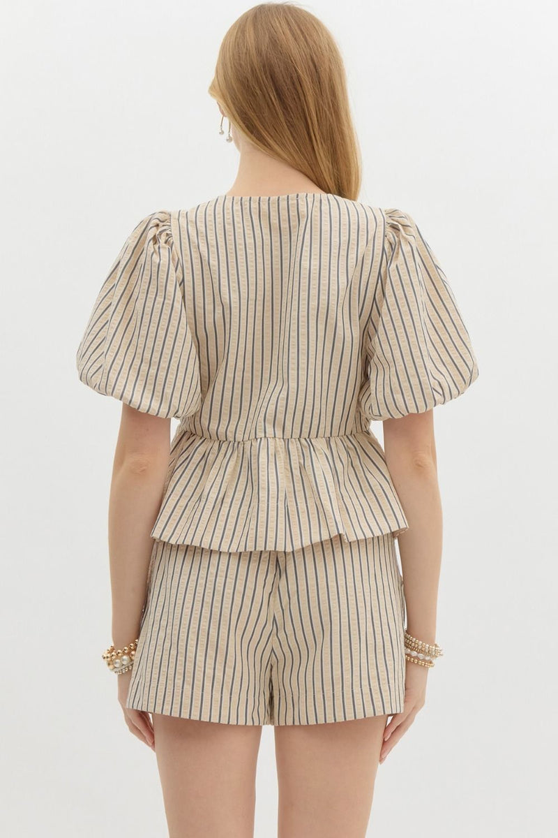 Striped Serenity Peplum Blouse with puff sleeves, bow-tie details, and a flattering peplum waist, styled with matching striped shorts for a chic, coordinated look.