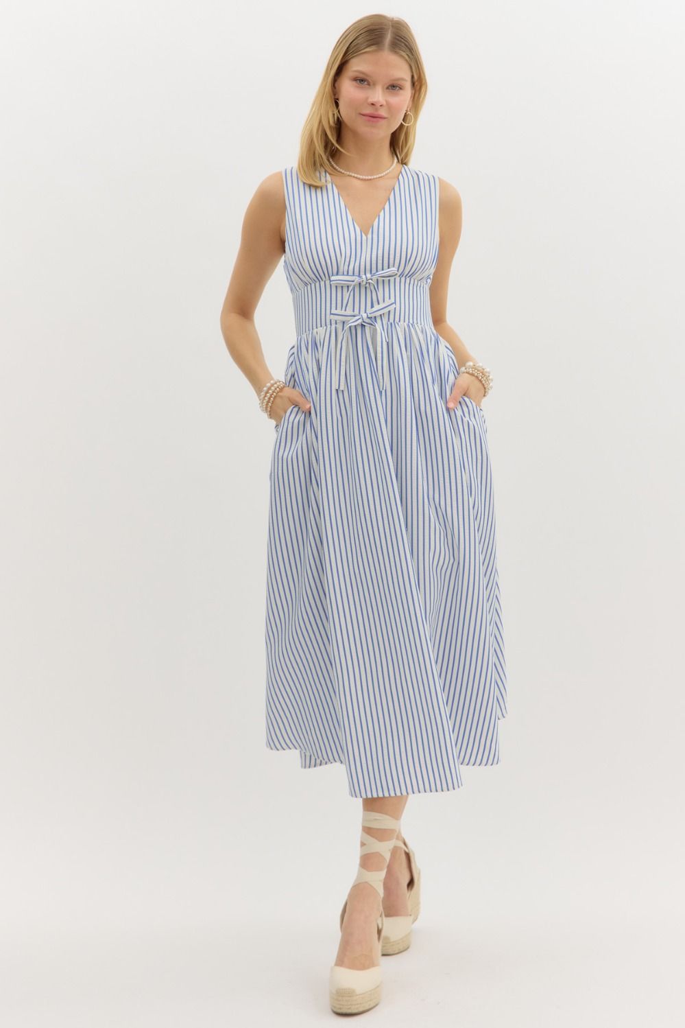 Striped sleeveless midi dress with front bow and smocked back waist.