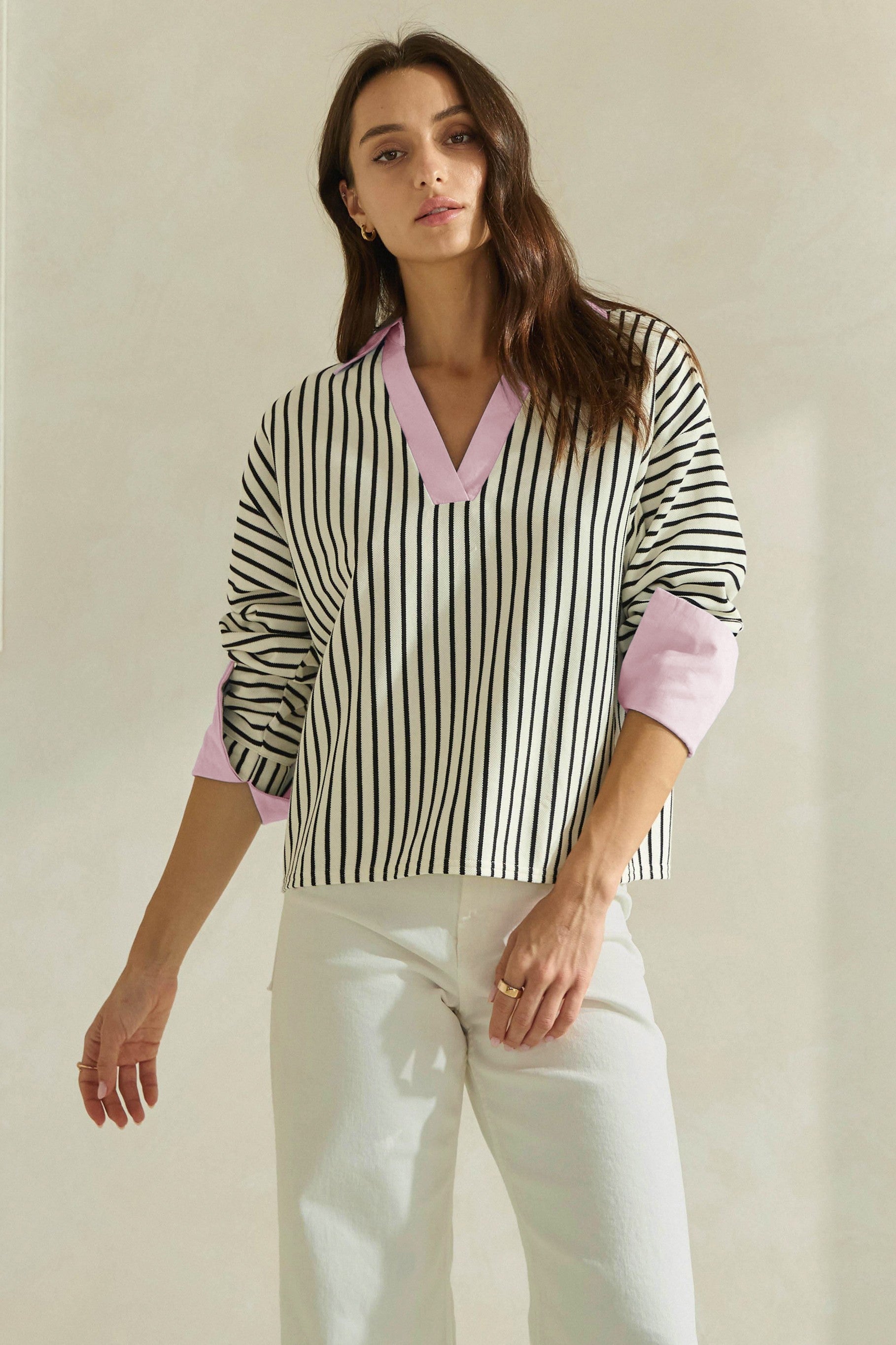 A timeless striped knit top featuring a flattering V-neckline, contrast neckline and cuffs, and an effortlessly polished silhouette.